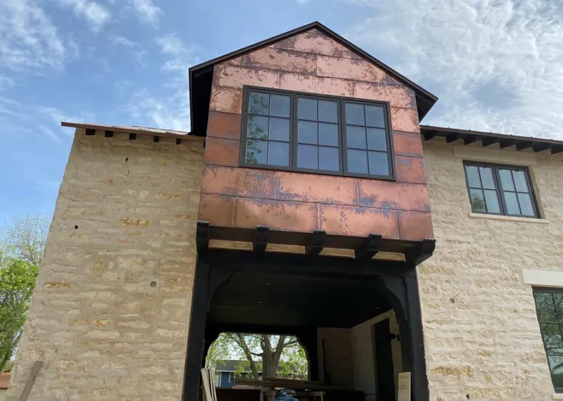 Copper metal panel facade on a stone building for Skylight Installation in Lake Wales