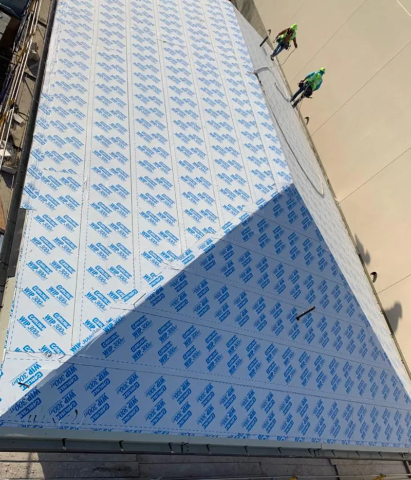 Professional roofers installing underlayment on a metal roof in Lake Wales